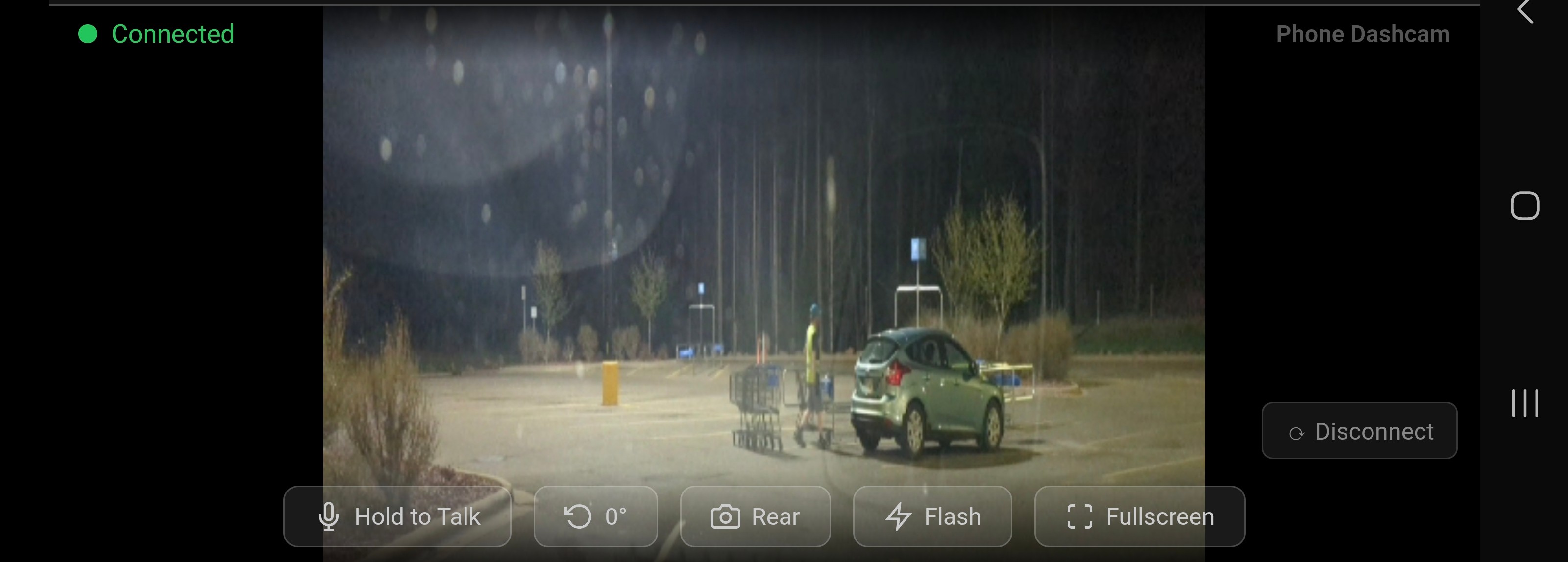 Phone Dashcam remote viewer showing rear camera live feed of parking lot at night