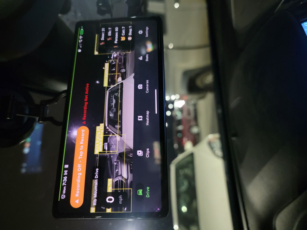 Phone Dashcam AI detection with Vehicle Braking and Pedestrian bounding boxes in parking lot