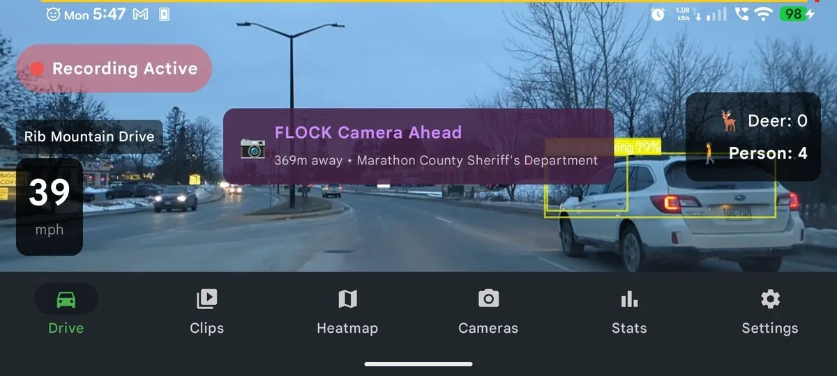 Phone Dashcam FLOCK Camera Ahead alert with AI detection bounding boxes at 39 mph