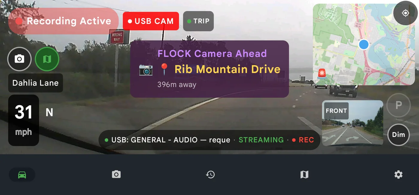 DriveSight drive screen warning of a Flock license plate camera 396 metres ahead, with a USB rear camera feed in the corner
